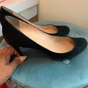 Christian Louboutin black suede pumps.